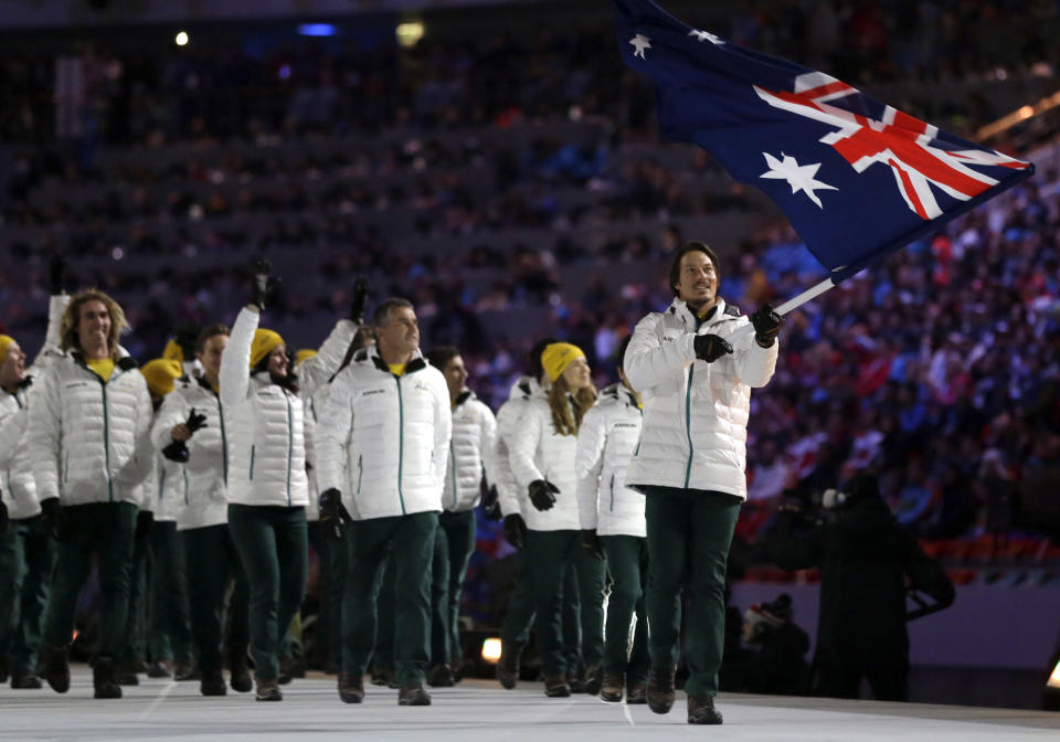 Alex Pullin of Australia carries the national flag as he leads the team during the opening ceremony of the 2014 Winter Olympics in Sochi, Russia, Friday, Feb. 7, 2014. (AP Photo/Patrick Semansky)