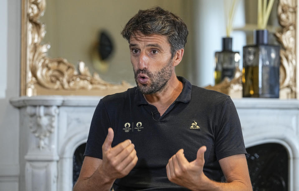 Tony Estanguet, the head of Paris 2024, the organizing committee of the Paris 2024 Games, gestures as he speaks during an interview with The Associated Press in Paris, Friday, Aug. 25, 2023. The host city of Paris vowed to deliver an extraordinary grand opening on July 26, 2024, as the ceremony is expected to draw about 600,000 spectators to the Parisian quayside. Citing security measures, the Paris police prefecture ordered on July 25 the removal of 570 stationary boxes out of which booksellers have operated for decades on the quays of the Seine river. (AP Photo/Michel Euler)