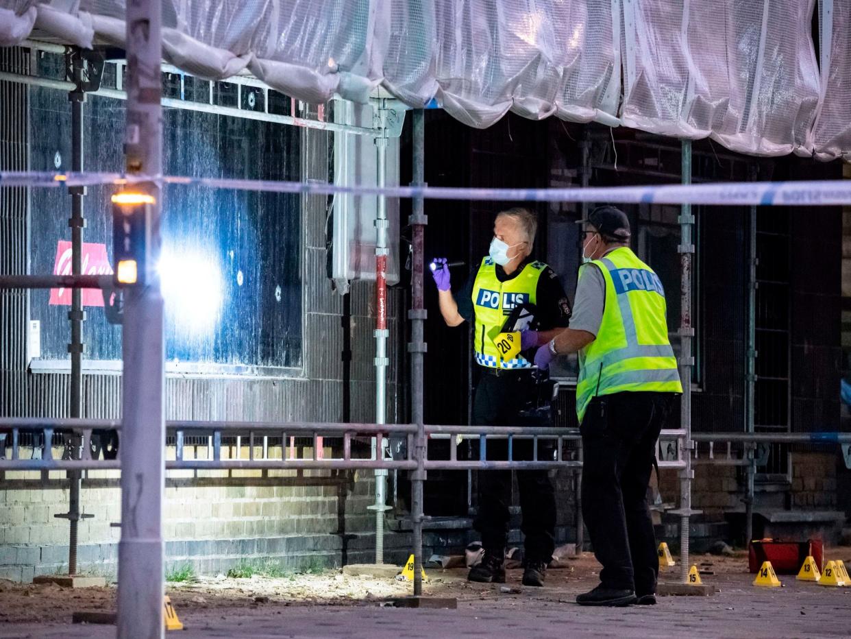 Policemen search the scene after a shooting in the Swedish city of Malmo: JOHAN NILSSON/AFP/Getty Images