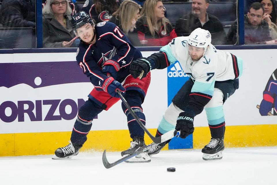 Mar 3, 2023; Columbus, Ohio, USA;  Columbus Blue Jackets defenseman Nick Blankenburg (77) passes around Seattle Kraken right wing Jordan Eberle (7) during the second period of the NHL hockey game at Nationwide Arena. Mandatory Credit: Adam Cairns-The Columbus Dispatch