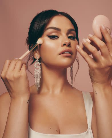 Rare Beauty Selena Gomez models products from her beauty brand Rare Beauty.