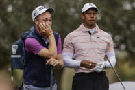 Justin Thomas, left, and Tiger Woods, right, talk during the first round of the PNC Championship golf tournament Saturday, Dec. 16, 2023, in Orlando, Fla. (AP Photo/Kevin Kolczynski)