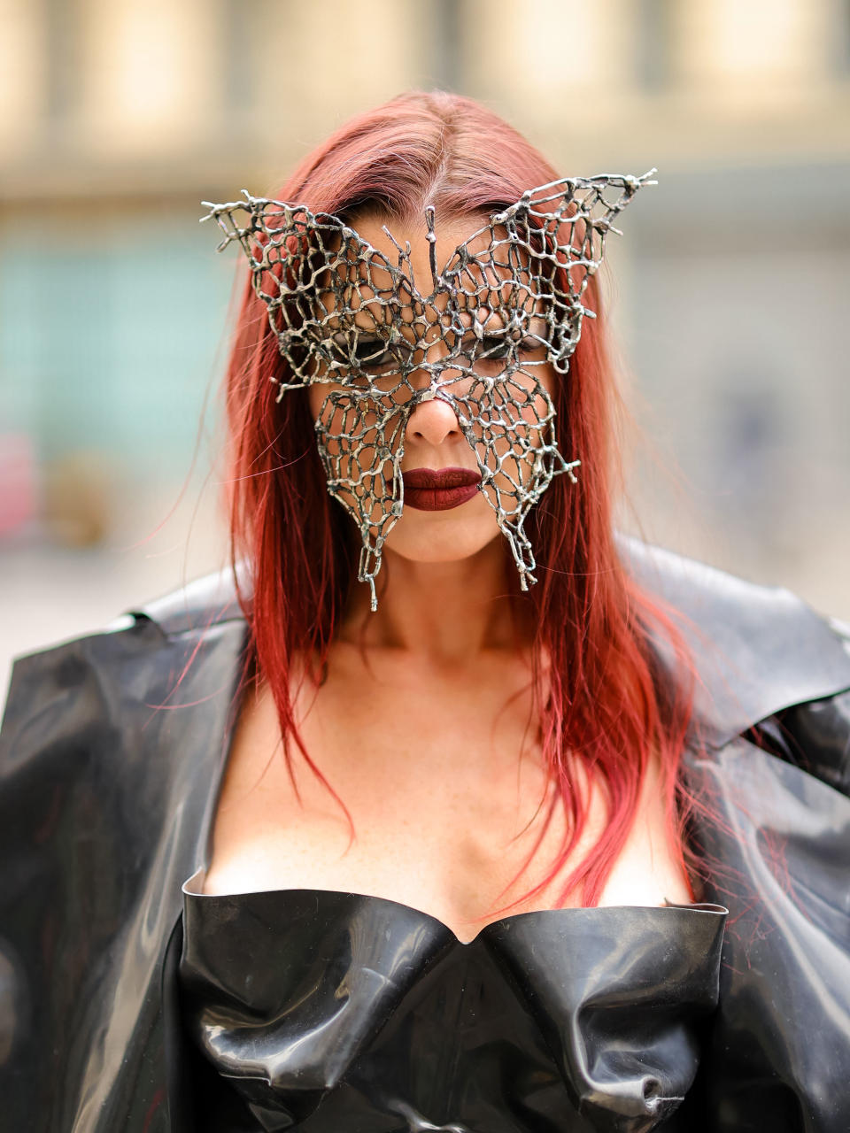 closeup of julia with a metal butterfly mask over her face