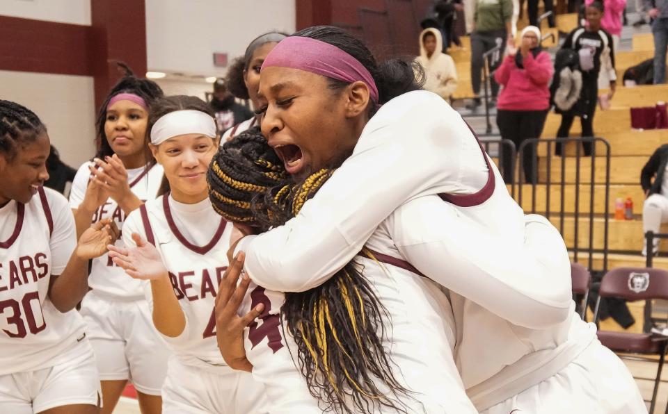 Lawrence Central Bears guard Jaylah Lampley (10) and Lawrence Central Bears guard Laila Abdurraqib (44) hug Thursday, Dec. 7, 2023, after the game at Lawrence Central High School in Indianapolis. The Lawrence Central Bears defeated the Lawrence North Wildcats, 57-55.