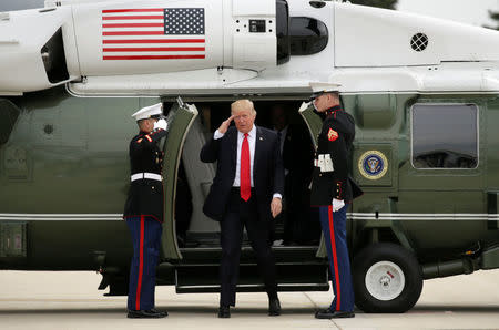 U.S. President Donald Trump returns a salute as he steps from Marine One to board Air Force One as he departs Milwaukee, Wisconsin, U.S., April 18, 2017. REUTERS/Kevin Lamarque