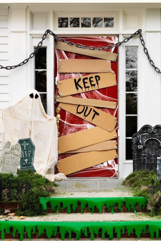 <p>An unwelcoming entryway is perfect for Halloween. To get the look, stretch cobwebs to somewhat cover the door and secure them with masking tape. Cut cardboard to resemble various-size wood slats. Paint a "Keep Out" sign on two of the slats and glue bolts to each piece of cardboard. Tape the slats to the door and you're done.</p><p><strong>RELATED: </strong><a href="https://www.goodhousekeeping.com/holidays/halloween-ideas/g1566/easy-halloween-craft-ideas/" rel="nofollow noopener" target="_blank" data-ylk="slk:Easy Halloween Crafts for Adults Who Love All Things Spooky and Spidery;elm:context_link;itc:0;sec:content-canvas" class="link ">Easy Halloween Crafts for Adults Who Love All Things Spooky and Spidery</a></p>