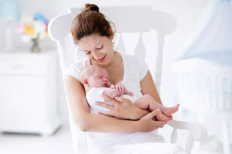 Young mother holding her newborn child.