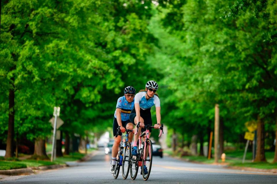 Cyclists ride along Selwyn Avenue under a canopy of trees along the “Booty Loop” bicycle course in Charlotte in April 2022.