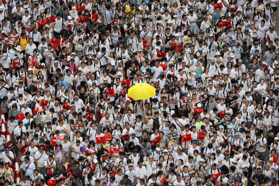 A protester holds up a yellow umbrella as he marches with thousands of others in a rally against the proposed amendments to extradition law in Hong Kong, Sunday, June 9, 2019. One year ago, a sea of humanity _ a million people by some estimates _ marched through central Hong Kong on a steamy afternoon. It was the start of what would grow into the longest-lasting and most violent anti-government movement the city has seen since its return to China in 1997. (AP Photo/Kin Cheung, File)