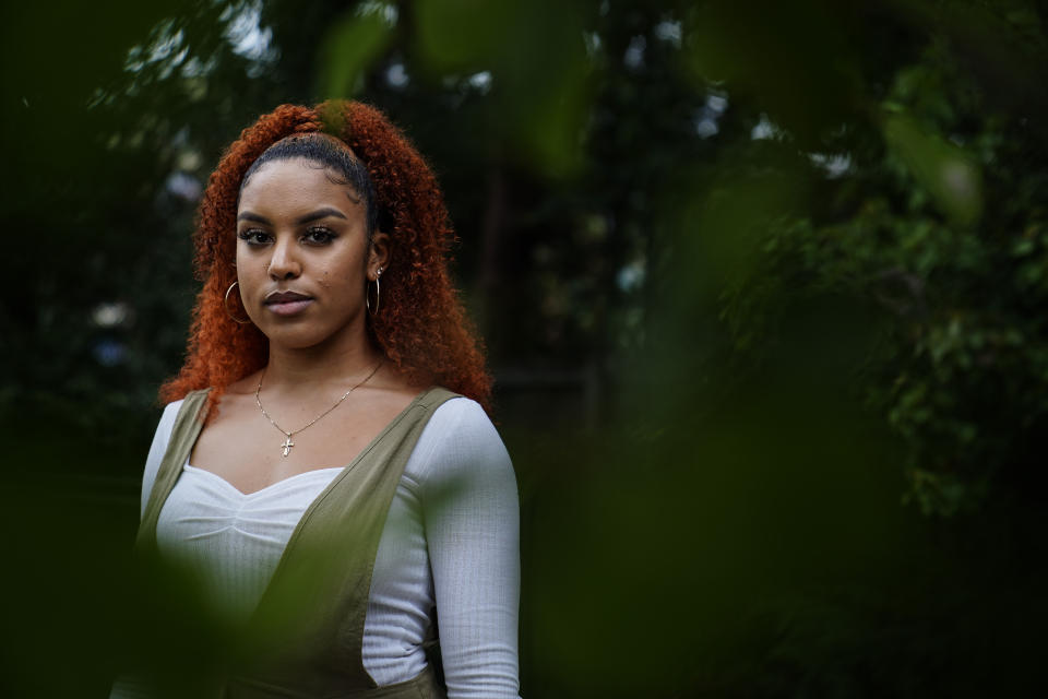 Olivia Musoke, 19, a direct descendant of a Pilgrim who came over on the Mayflower, poses for a portrait in Atlanta, on Friday, Sept 25, 2020. "Considering my ancestors helped incite the racial hierarchies that caused the need for these movements now, I do feel ashamed that that had to be part of history," said Musoke, whose ancestor on her mother's side arrived in America on the Mayflower. Musoke, whose father is Black, said the pride she feels in coming from people who helped settle this country "gets diminished by the role they played in kind of manipulating and terrorizing people of color, which trickled down to the structures we have today." (AP Photo/Brynn Anderson)