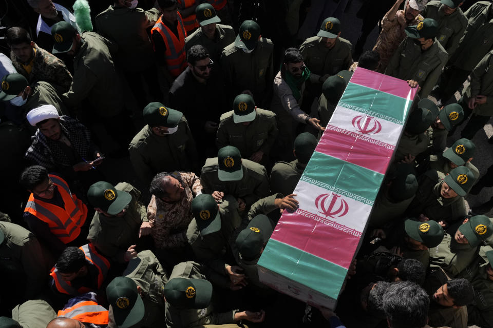 Revolutionary Guard members carry the flag-draped coffin of a victim of Wednesday's bomb explosion, during the victims funeral ceremony in the city of Kerman about 510 miles (820 kms) southeast of the capital Tehran, Iran, Friday, Jan. 5, 2024. Iran on Friday mourned those slain in an Islamic State group-claimed suicide bombing targeting a commemoration for a general slain in a U.S. drone strike in 2020. (AP Photo/Vahid Salemi)