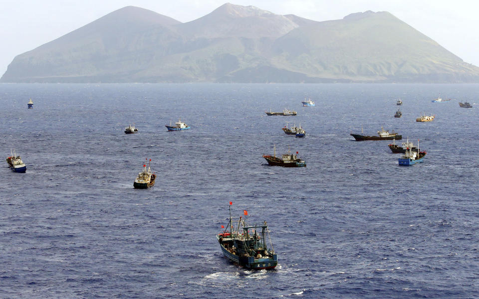 Foreign vessels, some of them have Chinese flags, fish near Torishima, Japan, on Oct. 31, 2014. A Chinese scientific ship bristling with surveillance equipment docked in a Sri Lankan port. Hundreds of fishing boats anchored for months at a time among disputed islands in the South China Sea. And ocean-going ferries, built to be capable of carrying heavy vehicles and large loads of people. (Kyodo News via AP)