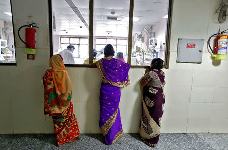 Women look into the Intensive care unit in the Baba Raghav Das hospital in Gorakhpur district, India August 14, 2017. REUTERS/Cathal McNaughton