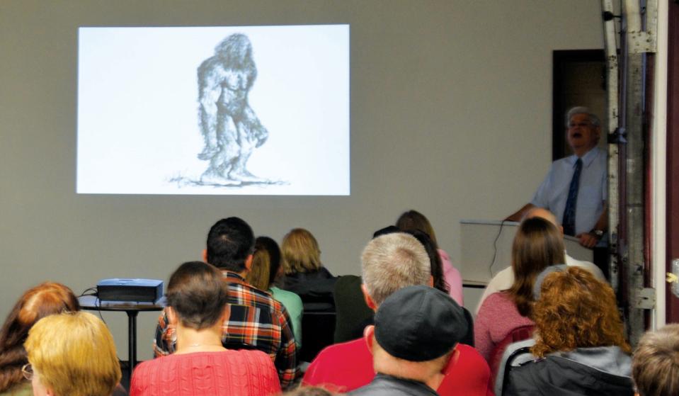 Bigfoot and UFO researcher and author Stan Gordon, background right, talks about his research during an event hosted in 2018 by the Daily American.
