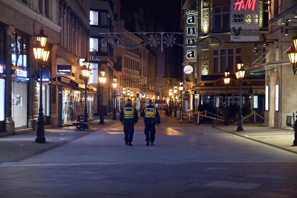 FILE - In this Nov. 11, 2020, file photo, police officers control the traffic in downtown Budapest during the curfew of the state of emergency as part of the containment measures of COVID-19 in Budapest, Hungary. The European Union still hasn't completely sorted out its messy post-divorce relationship with Britain — but it has already been plunged into another major crisis. This time the 27-member union is being tested as Poland and Hungary block passage of its budget for the next seven years and an ambitious package aimed at rescuing economies ravaged by the coronavirus pandemic. (Zoltan Mathe/MTI via AP, File)