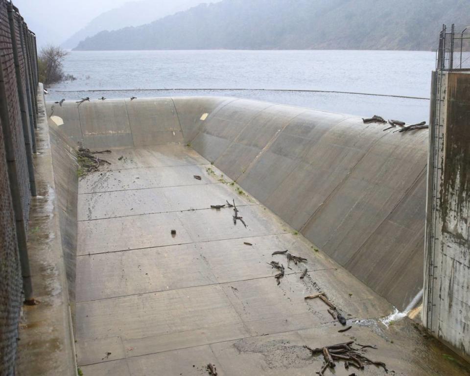 Lopez Lake trickles over its spillway on Feb. 7, 2024, after atmospheric river storms dumped several inches of rain on the reservoir’s watershed. David Middlecamp/dmiddlecamp@thetribunenews.com