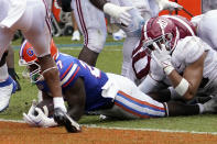 Florida running back Dameon Pierce, center, scores a touchdown past the Alabama defense including linebacker Henry To'oTo'o (10) during the second half of an NCAA college football game, Saturday, Sept. 18, 2021, in Gainesville, Fla. (AP Photo/John Raoux)