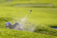 Jon Rahm, of Spain, hits out of a bunker on the 17th hole of the South Course at Torrey Pines during the third round of the Farmers Insurance Open golf tournament, Friday, Jan. 27, 2023, in San Diego. (AP Photo/Gregory Bull)