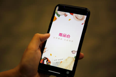 An app of the Chinese discount online retailer Vipshop Holdings Ltd is seen on a mobile phone in this illustration picture taken December 18, 2017. REUTERS/Florence Lo/Illustration