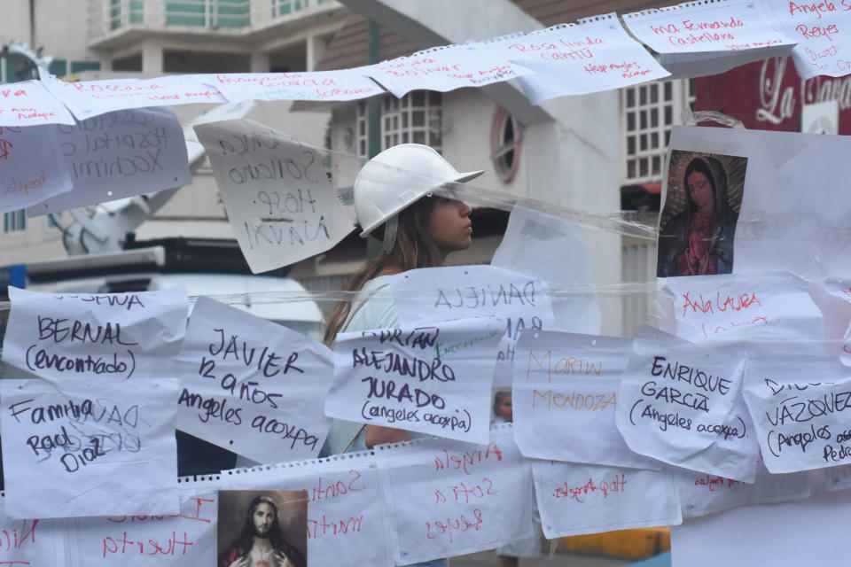 A woman is seen reading letters written to remember&nbsp;children who have died during the earthquake.&nbsp;