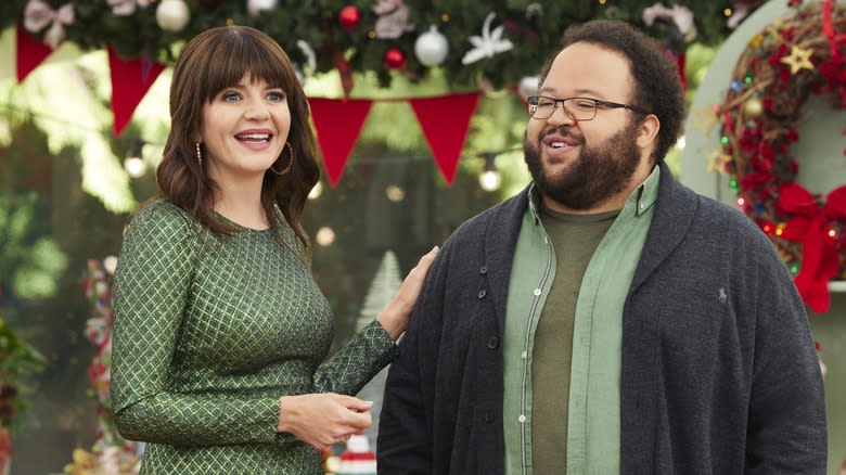 Zach Cherry and Casey Wilson standing on Great American Baking Show set 