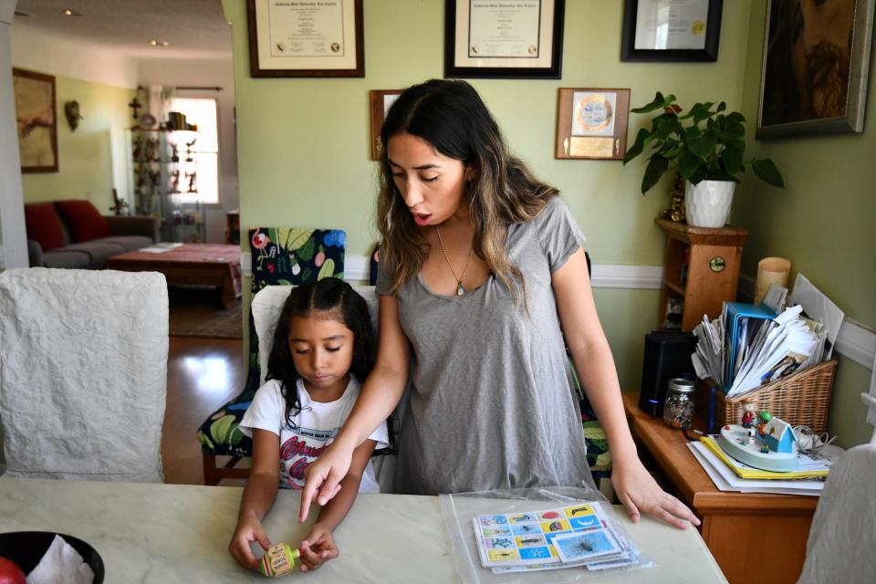 Linda Ortiz and her daughter, Sophie, prepare to play Lotería, a popular Spanish game. Sophie is part of a bilingual education class at UCLA Lab School, where she is learning 90% Spanish and 10% English.