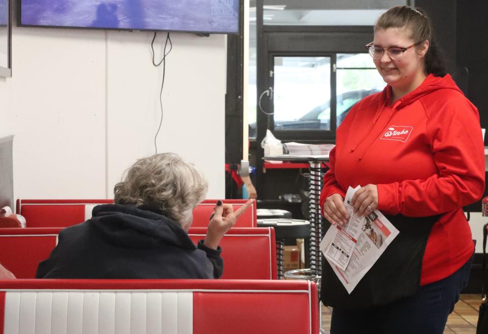 Kelsey Wood talks with a diner at Wink's Drive-In last week.