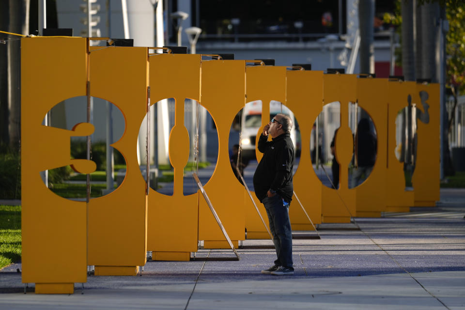 Un individuo observa las imágenes de la exhibición "3000" sobre la carrera de Roberto Clemente, en el estadio de los Marlins de Miami, el miércoles 31 de enero de 2024. (AP Foto/Rebecca Blackwell)