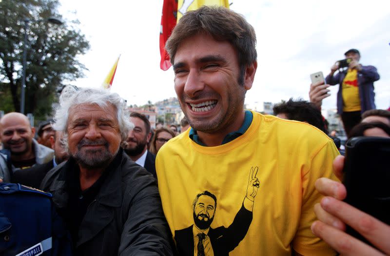 FILE PHOTO: 5-Star movement founder Beppe Grillo (L) and parliamentarian Alessandro Di Battista arrive during a rally for the regional election in the Sicilian village of Acitrezza near Catania