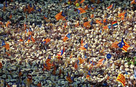 People hold Catalan separatist flags known as "Esteladas" during a gathering to mark the Catalonia day "Diada" in central Barcelona, Spain, September 11, 2016. REUTERS/Albert Gea