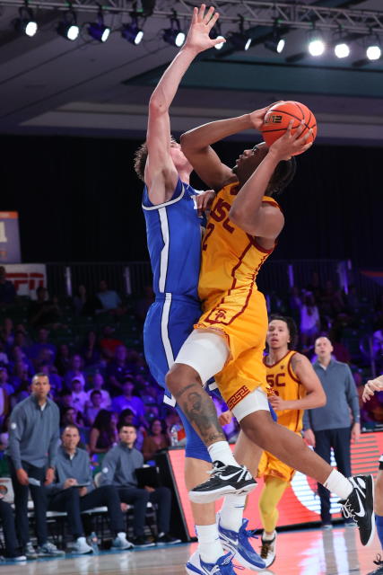 In a photo provided by Bahamas Visual Services, Southern California's Reese Dixon-Waters shoots against BYU forward Noah Waterman during an NCAA college basketball game in the Battle 4 Atlantis at Paradise Island, Bahamas, Wednesday, Nov. 23, 2022. (Tim Aylen/Bahamas Visual Services via AP)