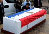 Feliciano Encina, father of Gustavo Encina, Paraguayan pilot of the crashed plane that carried the Brazilian team Chapecoense, cries next to the coffin of his son at the Silvio Pettirossi International Airport in Luque, Paraguay December 2, 2016. REUTERS/Jorge Adorno