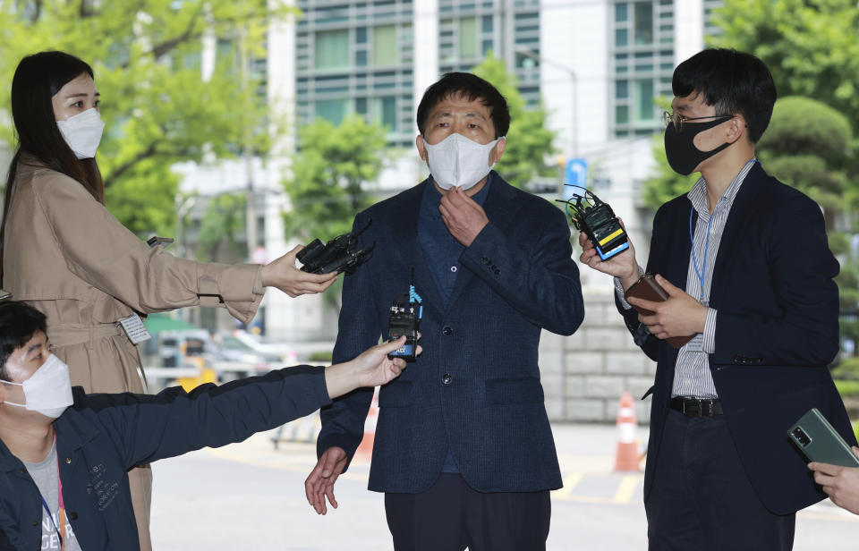 Park Sang-hak, center, speaks to the media upon his arrival at the Seoul Metropolitan Police Agency in Seoul, South Korea, Monday, May 10, 2021. South Korean police in Monday summoned the activist who said he flew hundreds of thousands of anti-Pyongyang propaganda leaflets toward North Korea in defiance of a new controversial law that criminalizes such activities. (Hong Hye-in/Yonhap via AP)