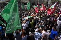 Relatives of 27-year-old Widad Deif, the wife of Hamas's military commander Mohammed Deif, carry her body during her funeral procession at the Jabaliya refugee camp in the northern Gaza Strip on August 20, 2014