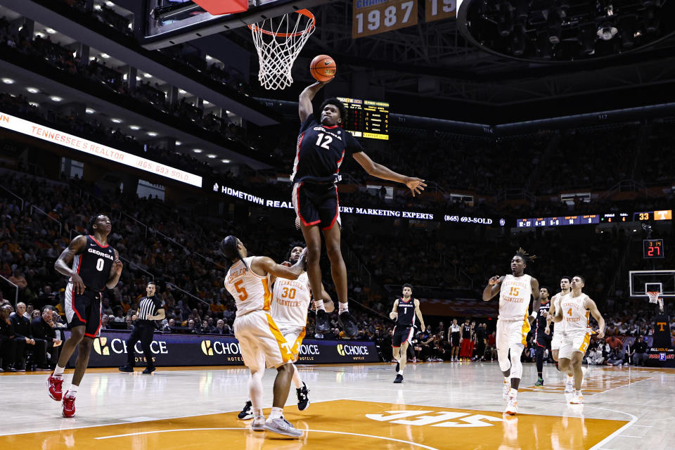 Georgia forward Matthew-Alexander Moncrieffe (12) dunks over Tennessee guard Zakai Zeigler (5) during the first half of an NCAA college basketball game Wednesday, Jan. 25, 2023, in Knoxville, Tenn. (AP Photo/Wade Payne)