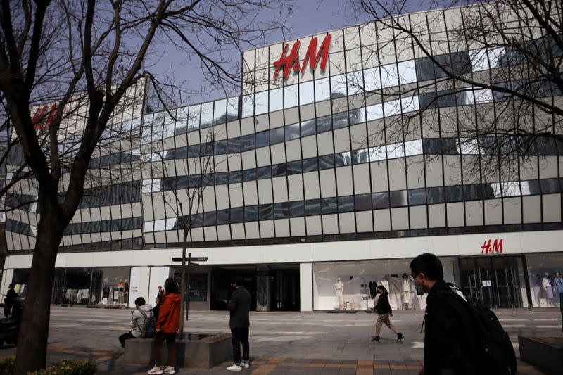 FILE PHOTO: People walk past an H&M store at a shopping complex in Beijing