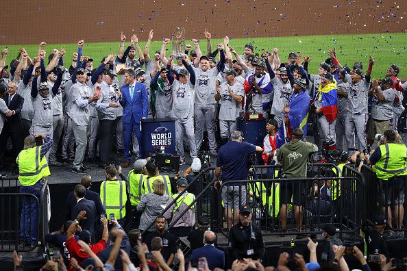 HOUSTON, TEXAS - NOVEMBER 02:  Manager Brian Snitker #43 of the Atlanta Braves hoists the commissioner's trophy following the team's 7-0 victory against the Houston Astros in Game Six to win the 2021 World Series at Minute Maid Park on November 02, 2021 in Houston, Texas. (Photo by Bob Levey/Getty Images)