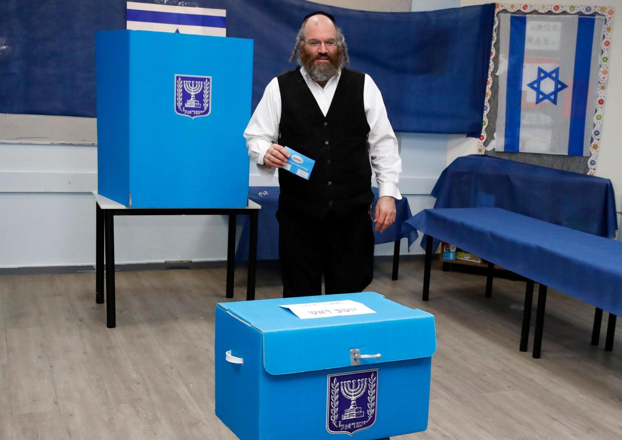 An ultra Orthodox Jewish man casts his ballot during Israel's parliamentary election, at a polling station in Rosh Haayin: JACK GUEZ/AFP/Getty Images