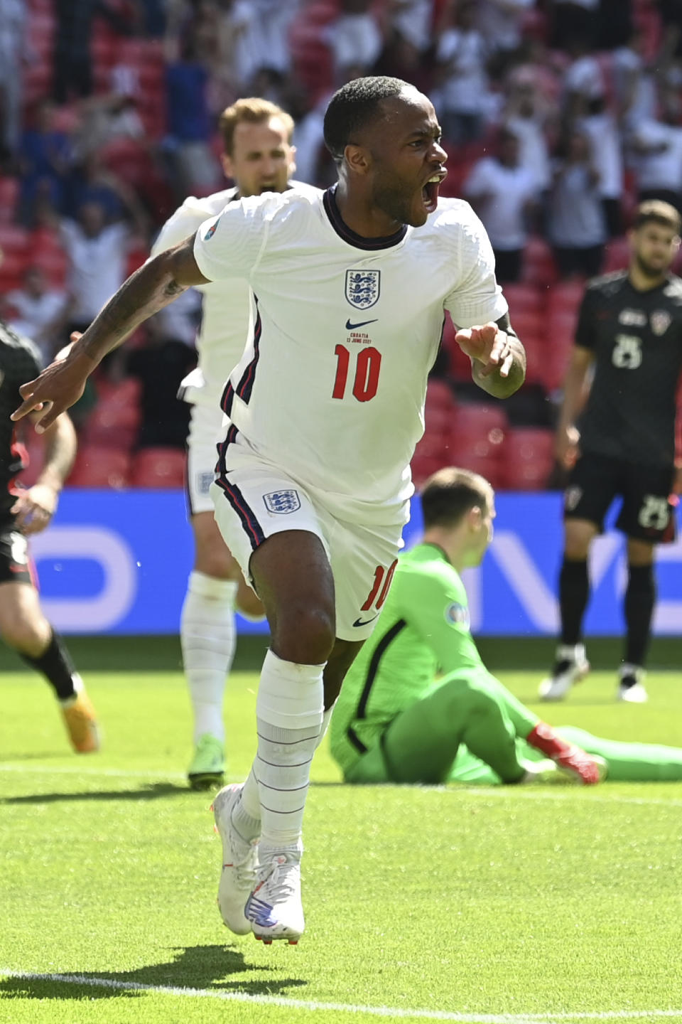 England's Raheem Sterling celebrates after scoring his side's opening goal during the Euro 2020 soccer championship group D match between England and Croatia at Wembley stadium in London, Sunday, June 13, 2021. (Glyn Kirk/Pool Photo via AP)