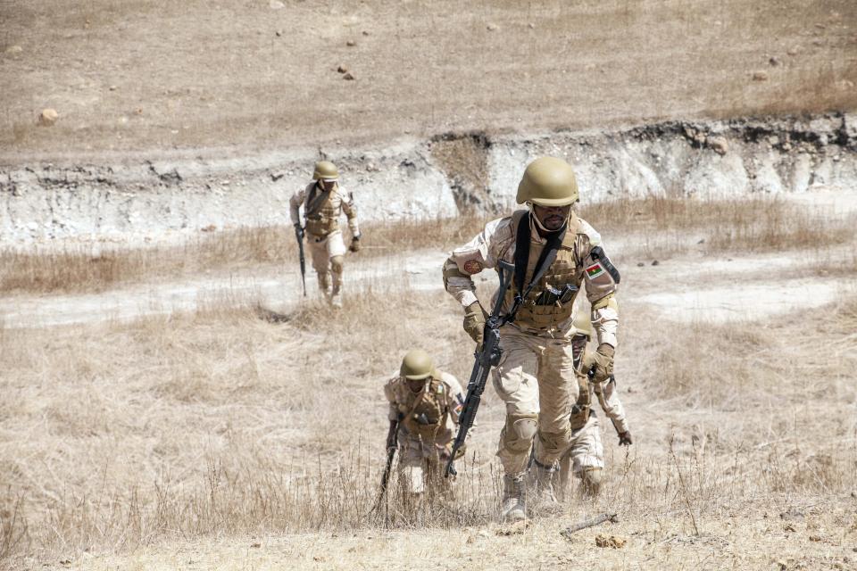 In this Tuesday Feb. 18, 2020, photo, Burkina Faso paratroopers commando exercise under the supervision of Dutch special forces during U.S. military-led annual counterterrorism exercise in Thies, Senegal. More than 1,500 service members from the armies of 34 African and partner training nations have assembled for the Flintlock exercises in Senegal and Mauritania, the two countries in West Africa's sprawling Sahel region that so far have not been hit by violence from extremists linked to al-Qaida or the Islamic State group. (AP Photo/Cheikh A.T Sy)