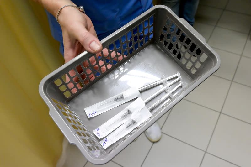 FILE PHOTO: Healthcare worker carries a tray of prepared doses of Pfizer-BioNTech COVID-19 vaccine at the Del-Pest Central Hospital as the coronavirus disease (COVID-19) outbreak continues, in Budapest