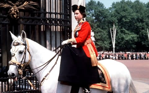 Queen Elizabeth II riding side-saddle as she returns to Buckingham Palace, London, after attending the Trooping the Colour ceremony on Horse Guards Parade in 1963 - Credit: PA