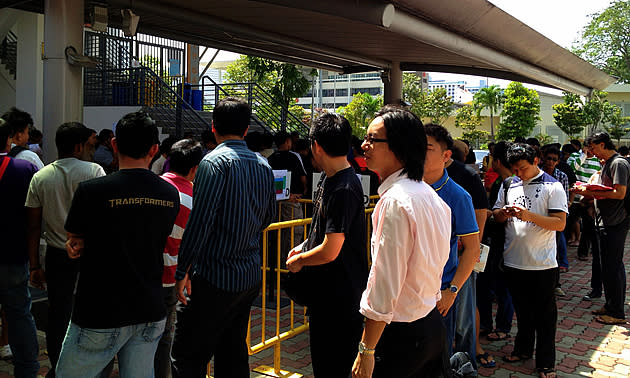 People queuing for tickets to S'pore's match against Kelantan at the Jalan Besar Stadium.