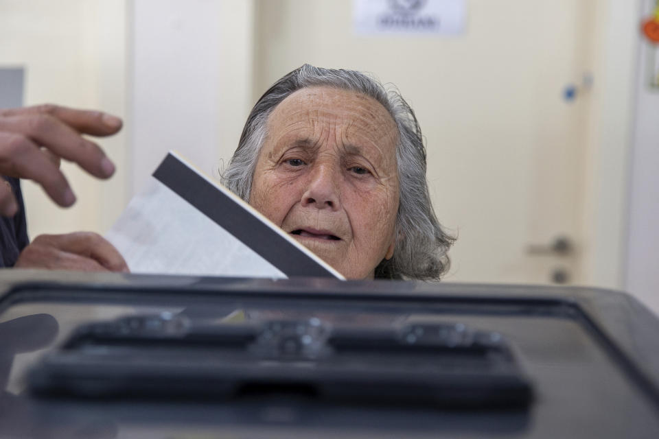 An Albanian woman casts her vote during parliamentary elections in capital Tirana, Albania on Sunday, April 25, 2021. Albanian voters have started casting ballots in parliamentary elections on Sunday amid the virus pandemic and a bitter political rivalry between the country's two largest political parties. (AP Photo/Visar Kryeziu)