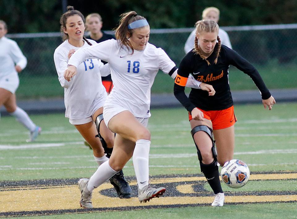 Ashland High School's Caley Biddinger (9) works with the ball against Anthony Wayne High School's Addison Williams (18) and Kate Kemmer (13) during their OHSAA Division I district final soccer match on Thursday, October 28, 2021 at Sylvania Northview High School. TOM E. PUSKAR/TIMES-GAZETTE.COM