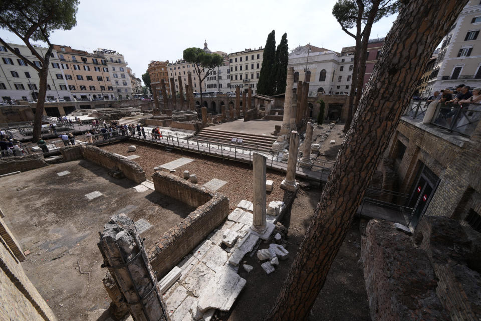 Journalists visit the new walkways of the so called 'Sacred Area' where four temples, dating back as far as the 3rd century B.C., stand smack in the middle of one of modern Rome's busiest crossroads, Monday, June 19, 2023, With the help of funding from Bulgari, the luxury jeweler, the grouping of temples can now be visited by the public that for decades had to gaze down from the bustling sidewalks rimming Largo Argentina (Argentina Square) to admire the temples below where Julius Caesar masterminded his political strategies and was later fatally stabbed in 44 B.C. (AP Photo/Domenico Stinellis)