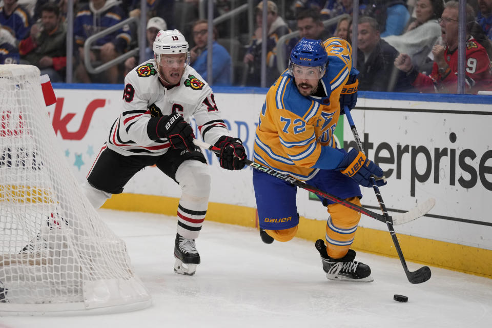 St. Louis Blues' Justin Faulk (72) handles the puck as Chicago Blackhawks' Jonathan Toews (19) defends during the third period of an NHL hockey game Thursday, Dec. 29, 2022, in St. Louis. (AP Photo/Jeff Roberson)