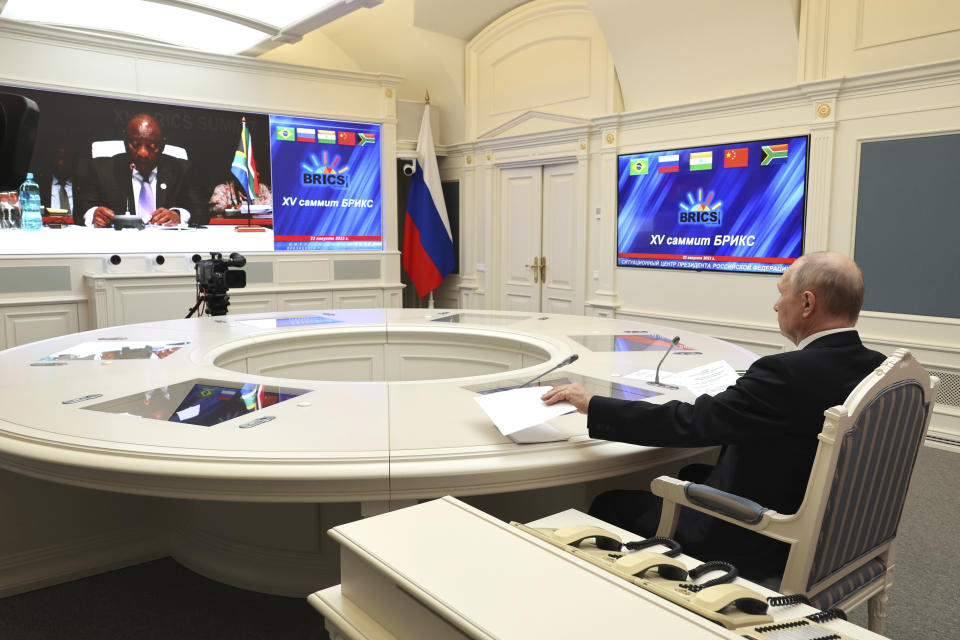 Russian President Vladimir Putin listens to leaders from the BRICS group of emerging economies at the start of a three-day summit in Johannesburg, South Africa via videoconference from Moscow, Russia, Wednesday, Aug. 23, 2023. Putin appeared on a video link after his travel to South Africa was complicated by an International Criminal Court arrest warrant against him over the war in Ukraine. (Mikhail Klimentyev, Sputnik, Kremlin Pool Photo via AP)