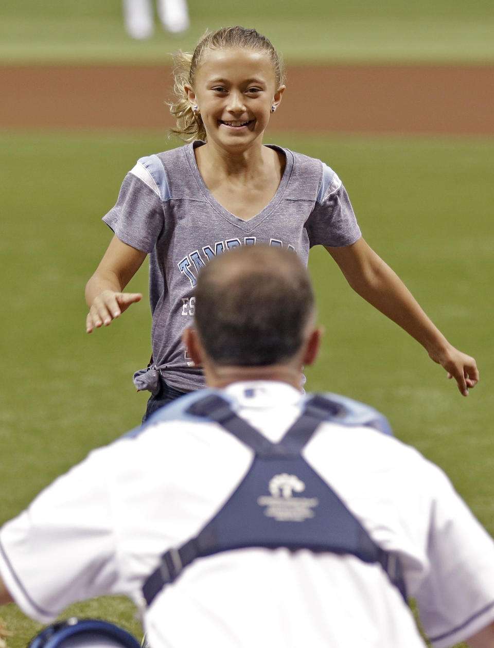 <p>Nine-year-old Alayna Adams runs to see her father, Army Lt. Col. William Adams, before a baseball game between the Tampa Bay Rays and the Boston Red Sox on Thursday, May 16, 2013, in St. Petersburg, Fla. Lt. Col. Adams, who had been stationed in Afghanistan, surprised his wife and daughter. (AP Photo/Chris O’Meara) </p>