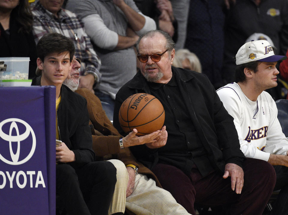 LOS ANGELES, CA - DECEMBER 18: Actor Jack Nicholson gives the game ball to record producer Lou Adler as they attend a basketball game between the Golden State Warriors and Los Angeles Lakers where Laker legend Kobe Bryant's jersey was retired at Staples Center on December 18, 2017 in Los Angeles, California. (Photo by Kevork S. Djansezian/Getty Images)